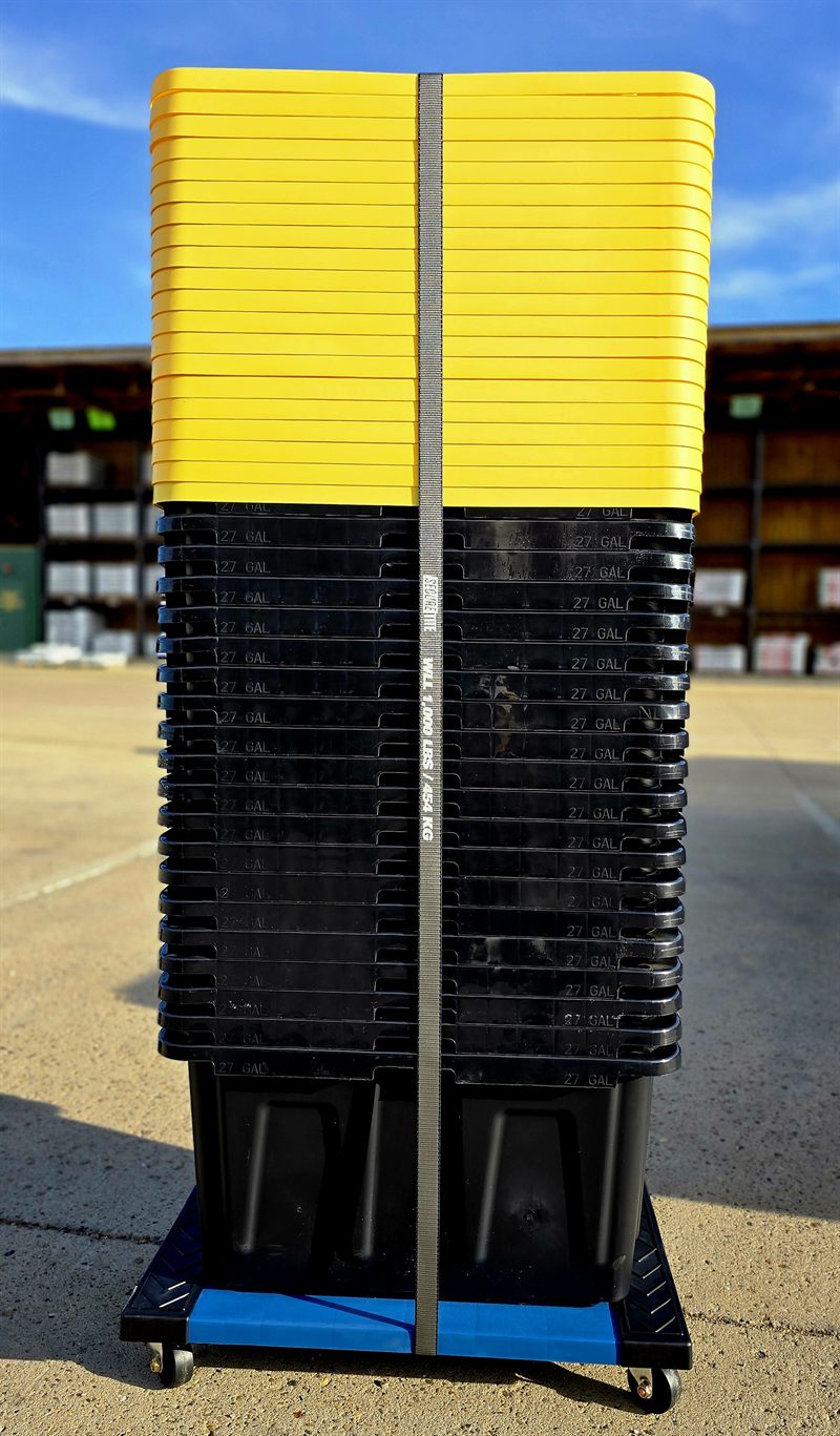 A strapped column of moving totes and lids secured to a Tote Cart with a rated cargo strap